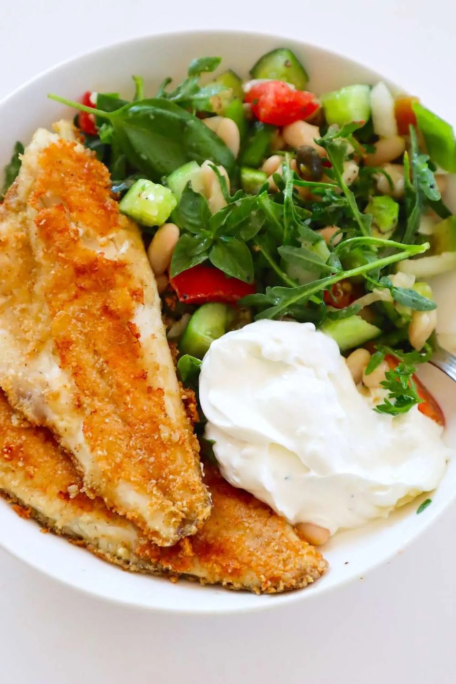 Mediterranean bowls with fried Branzino fillets, salad and tzatziki sauce - a satisfying fish recipe for dinner. The pan-fried franzino…