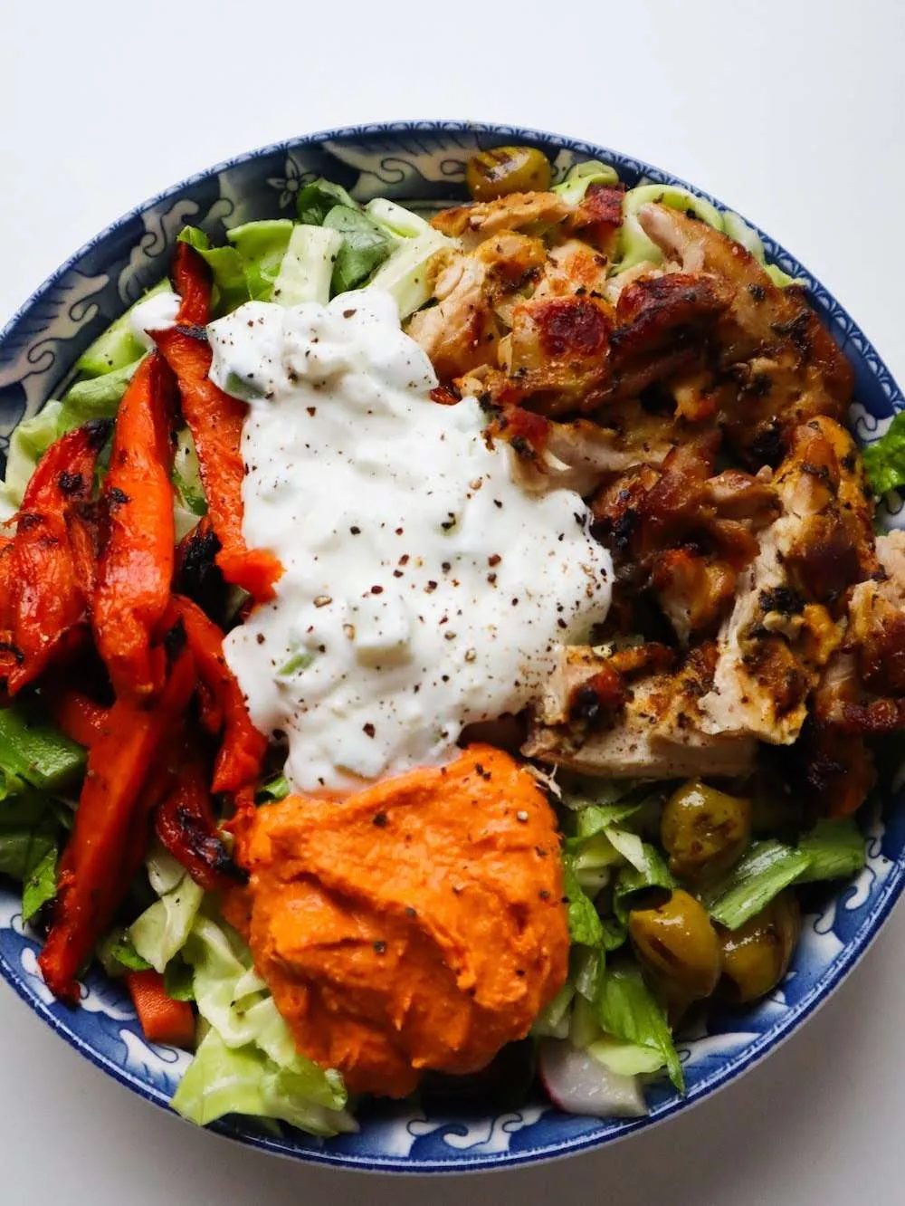 This Mediterranean recipe is made with chicken, sweet potatoes, red pepper hummus, tzatziki and of course - a salad of choice!