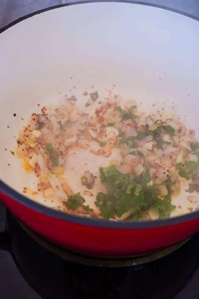 Sauté the onion and garlic with the crushed red pepper, grated ginger and olive oil in a cooking pot at medium-high for 1-2 minutes until…