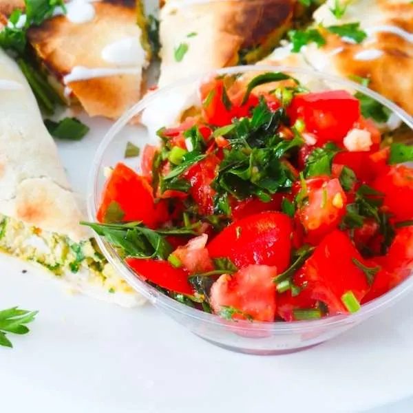 Simple tomato and mint salad with garlic - refreshing and satisfying side dish to use in wraps, bowls or with dinner!
