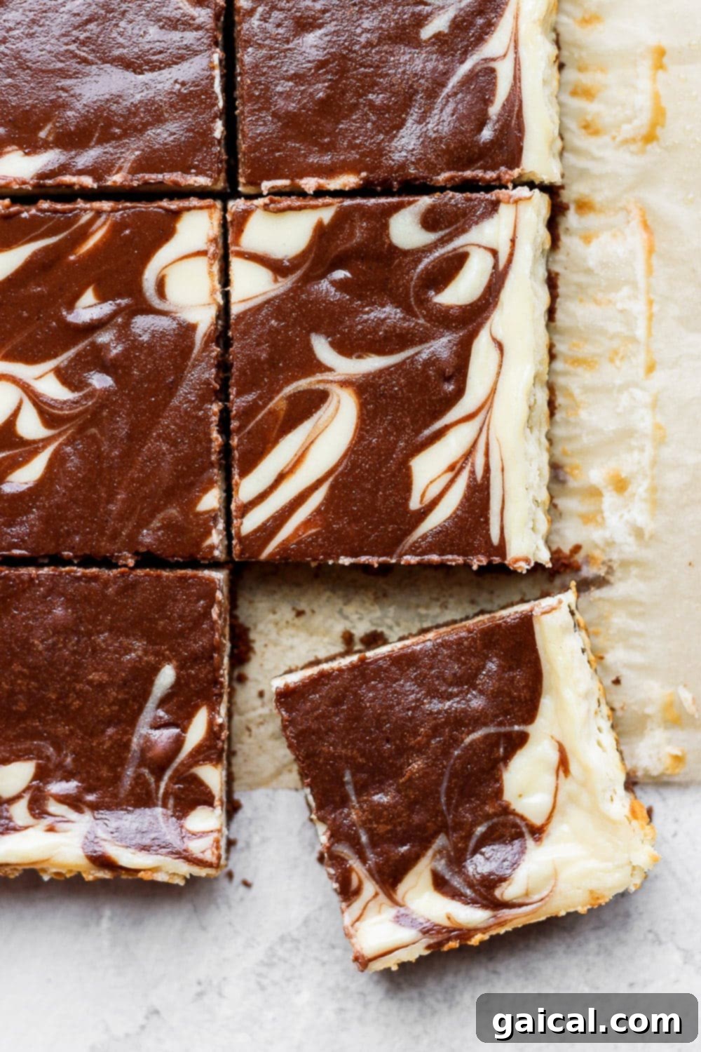 Beautifully swirled chocolate chai Greek yogurt cheesecake bars in a baking pan, ready to be sliced.