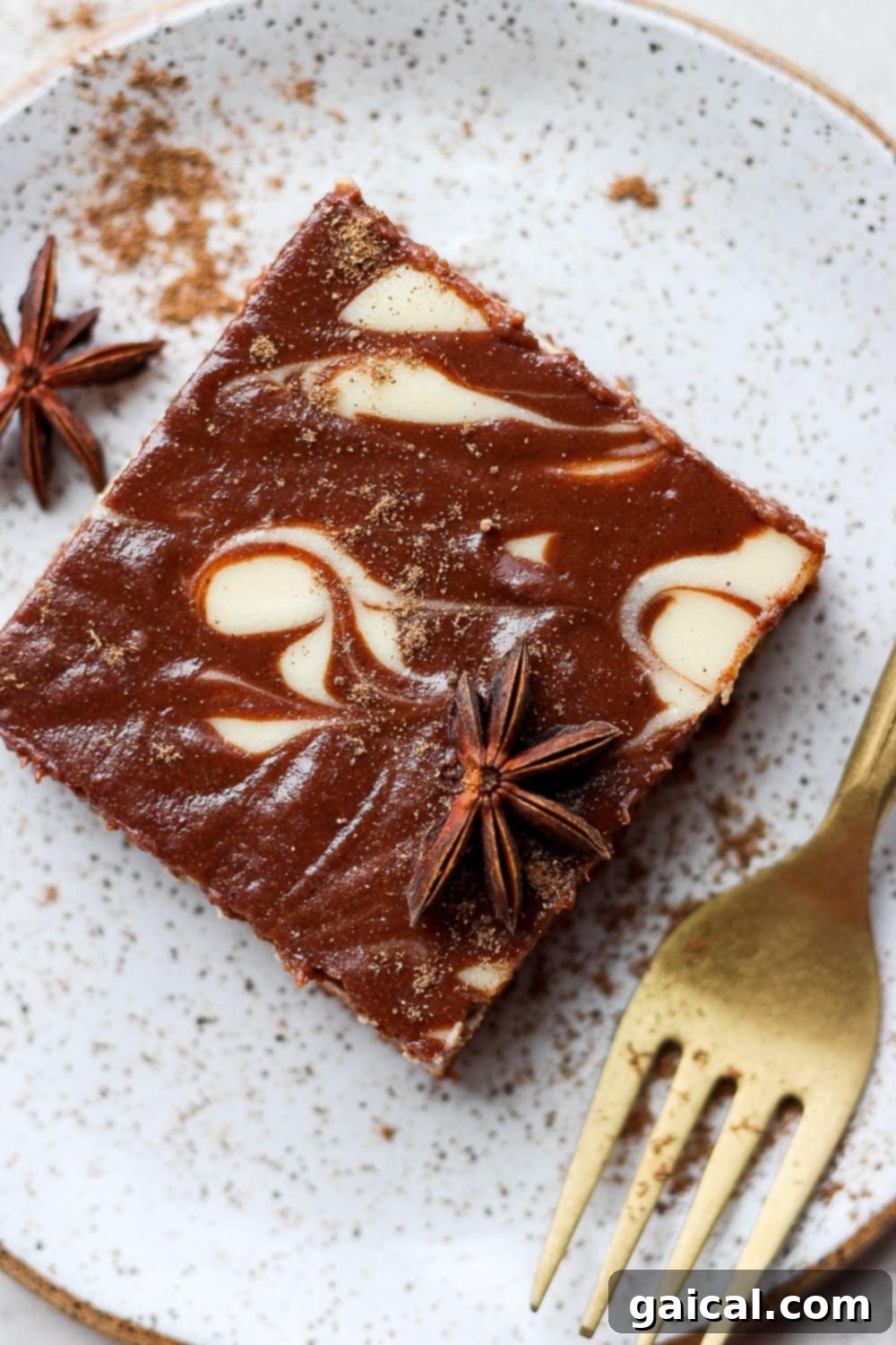 A single slice of chocolate chai Greek yogurt cheesecake bar on a white plate, showing the distinct swirl pattern.
