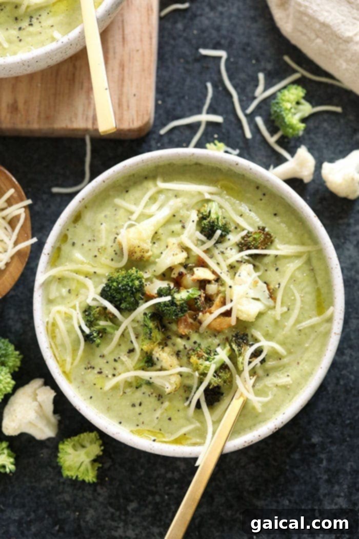 Cheesy Broccoli Cauliflower Delight 2 A bowl of creamy broccoli cauliflower cheese soup garnished with fresh herbs and a drizzle of cream.