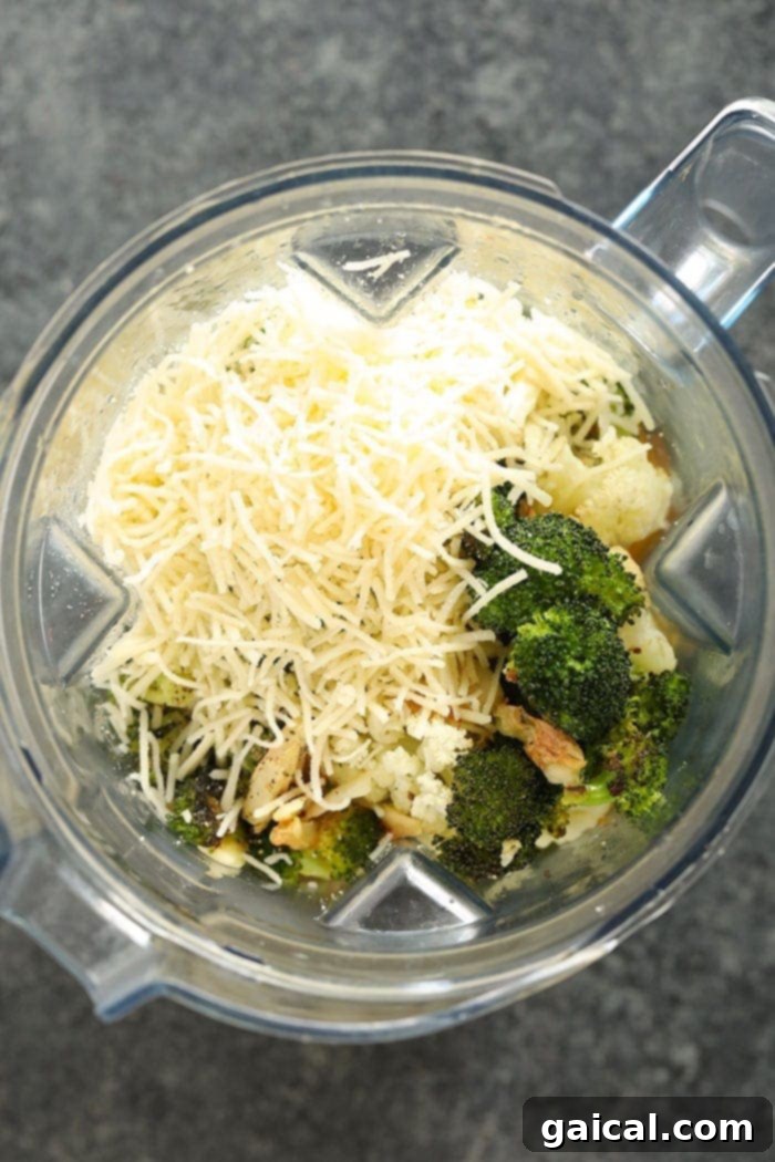 Cheesy Broccoli Cauliflower Delight 4 A high-speed blender filled with the lightened-up broccoli cauliflower cheese soup, mid-blend.