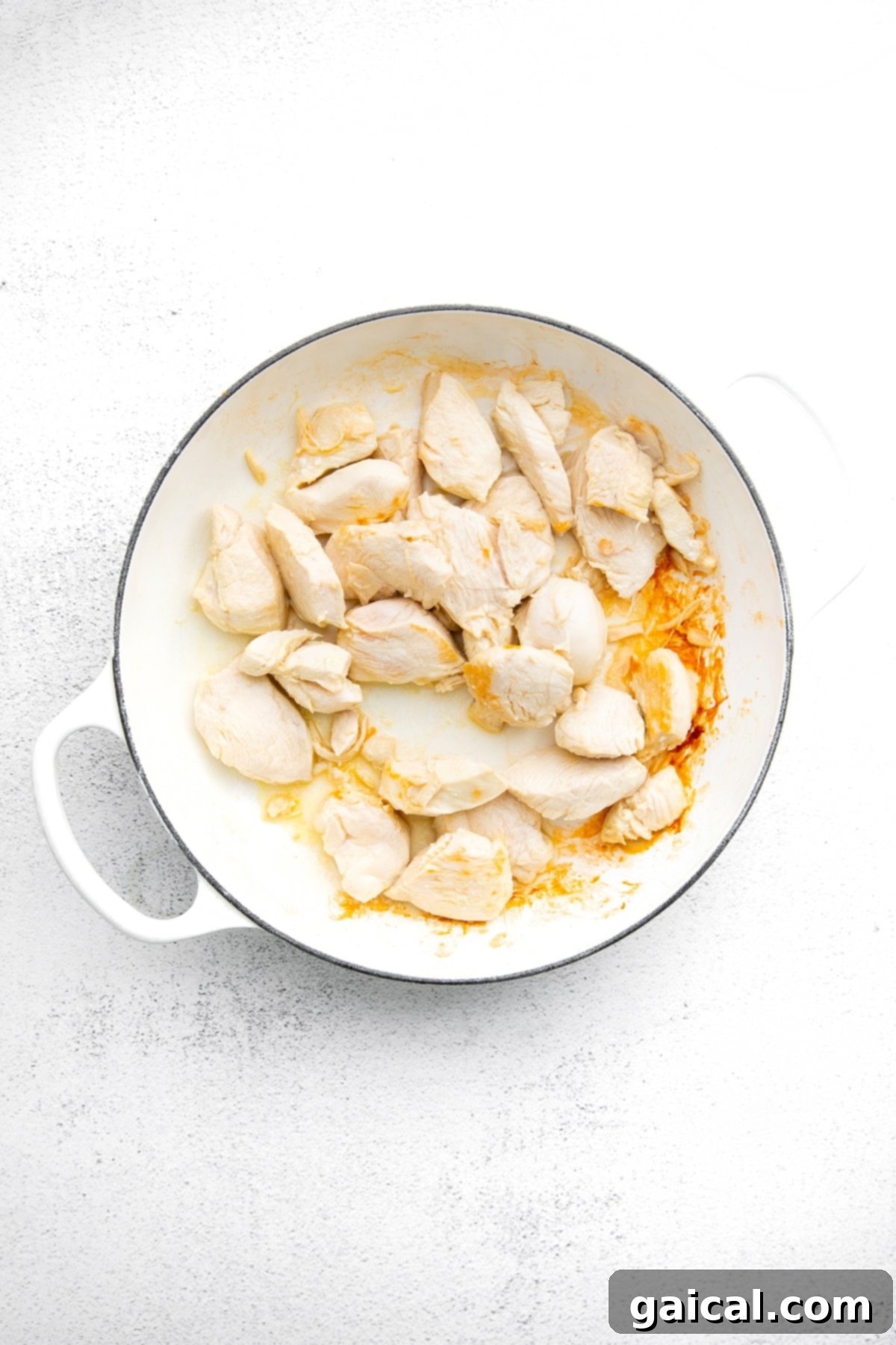 Perfectly Cooked Chicken for Kung Pao Stir Fry Diced boneless, skinless chicken breast cooking in a hot pan with olive oil, browning beautifully