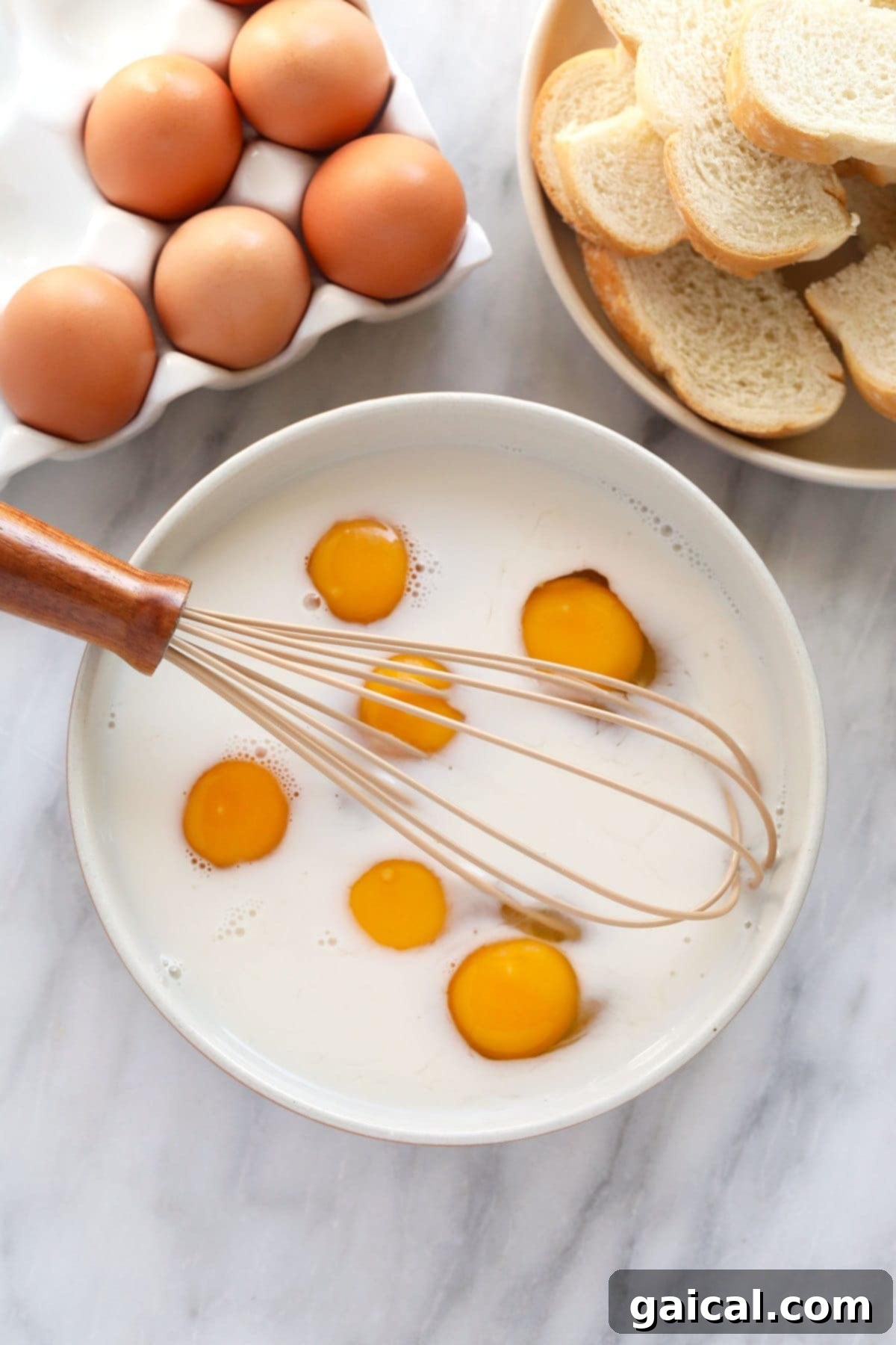 A bowl filled with egg and milk mixture, ready for whisking to prepare the batter for French Toast Sticks.