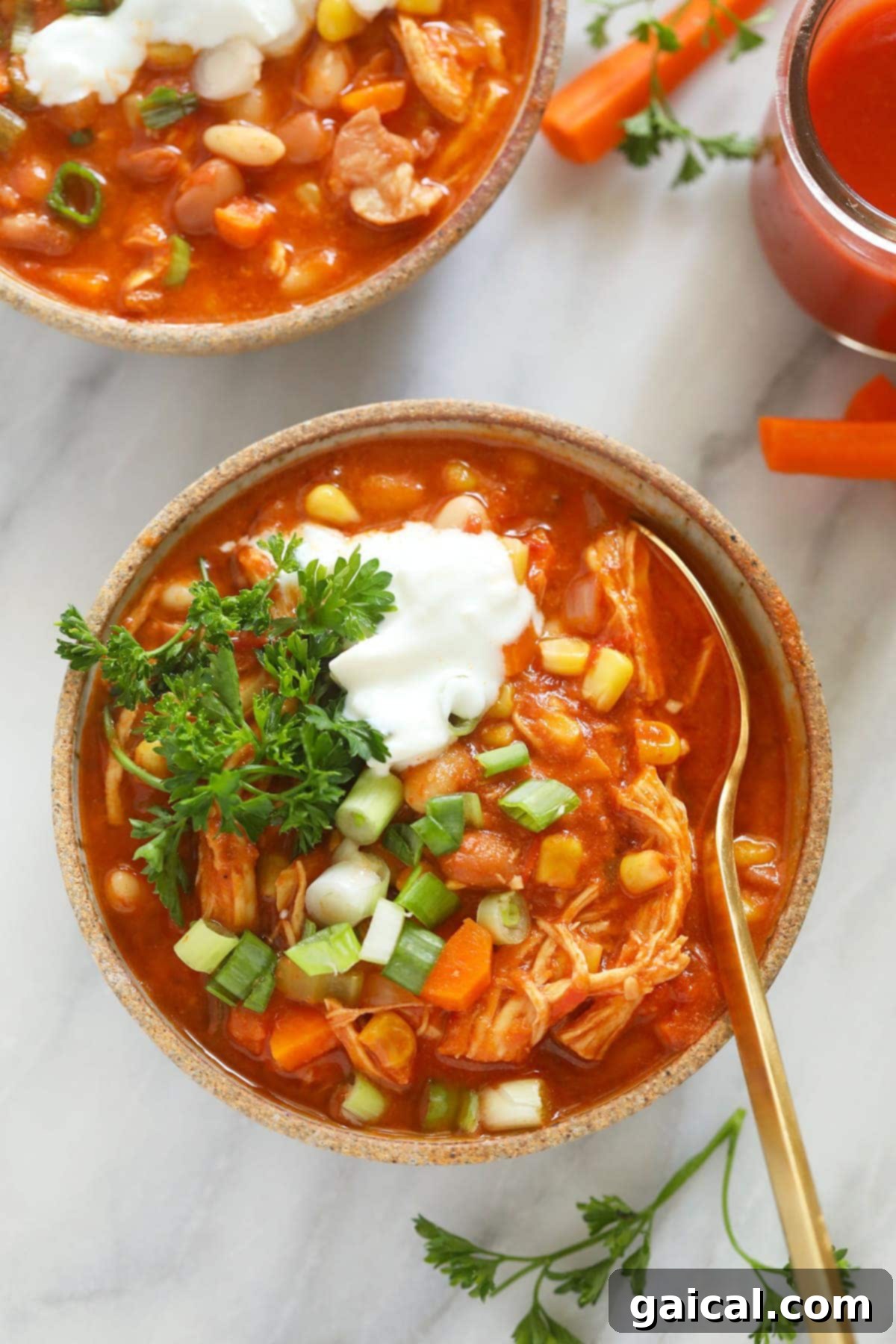 Zesty Instant Pot Buffalo Chicken Chili 2 A vibrant bowl of Instant Pot Buffalo Chicken Chili, garnished with fresh herbs and a spoon, ready to be enjoyed.