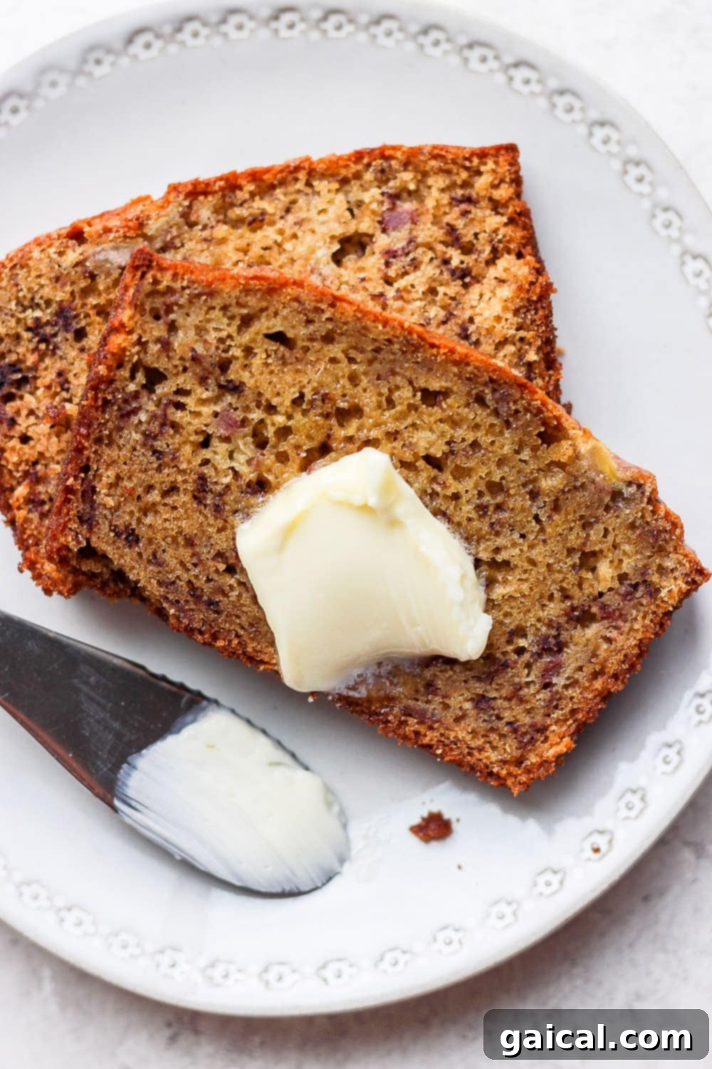 Whip up a batch of this easy healthy banana bread and top it with some butter for the best snack or breakfast. A delectable slice of healthy banana bread topped with a pat of butter, perfect for breakfast or a snack.