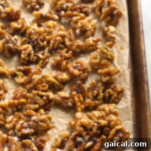 The Ultimate Thanksgiving Salad 3 Candied walnuts cooling on a sheet pan, ready to be added to a Thanksgiving salad.