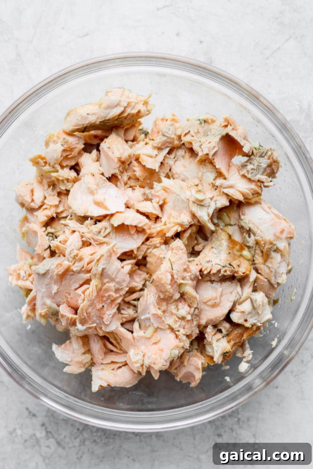 Learn how to make salmon patties with cooked flakey salmon, panko breadcrumbs, garlic, mayo, and a little tabasco. You will seriously love this salmon patties recipe! flaked salmon in a bowl