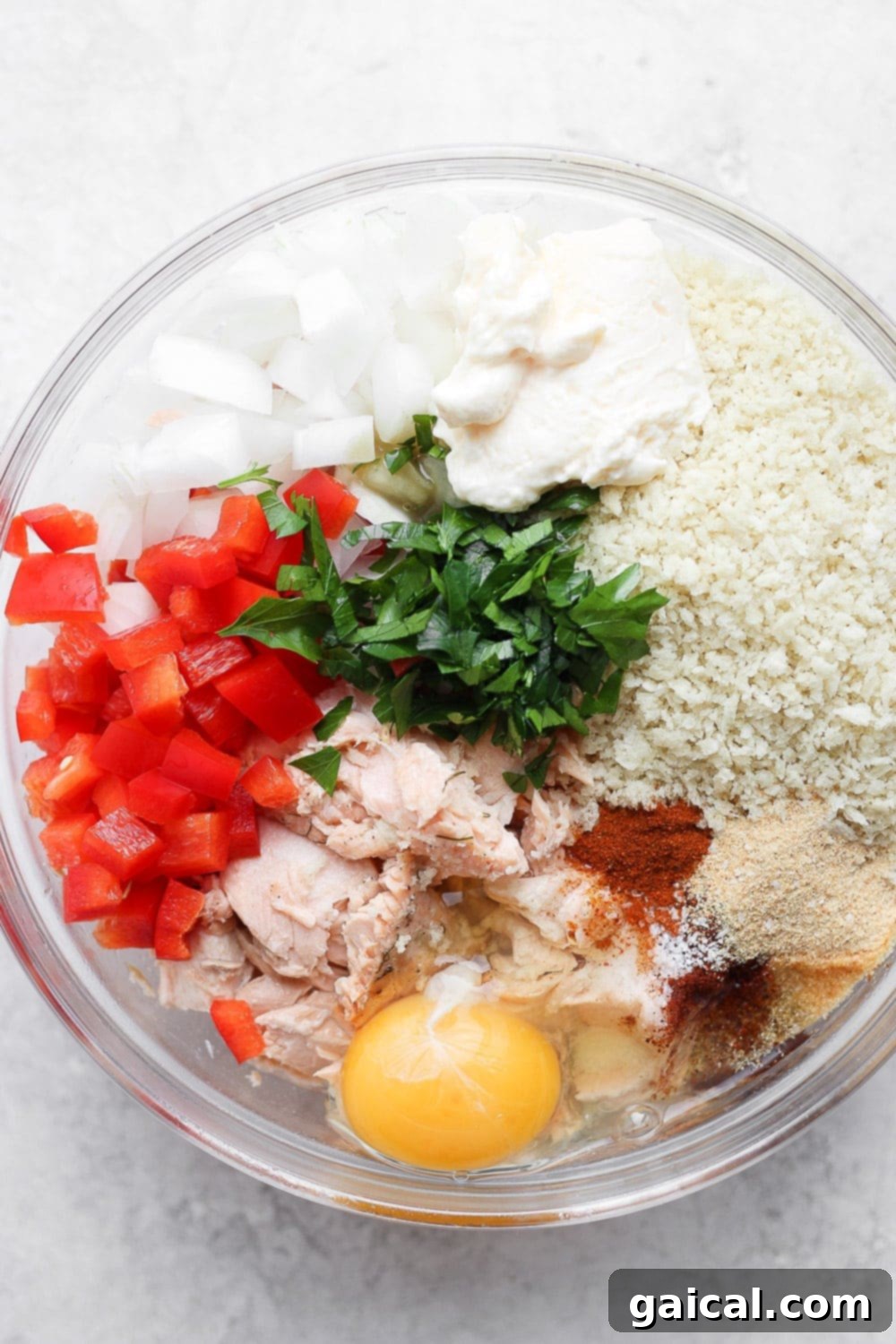 Got leftover salmon to use up? Make these super easy and delicious salmon patties for the perfect leftover meal today! salmon patties ingredients in a bowl ready to be mixed