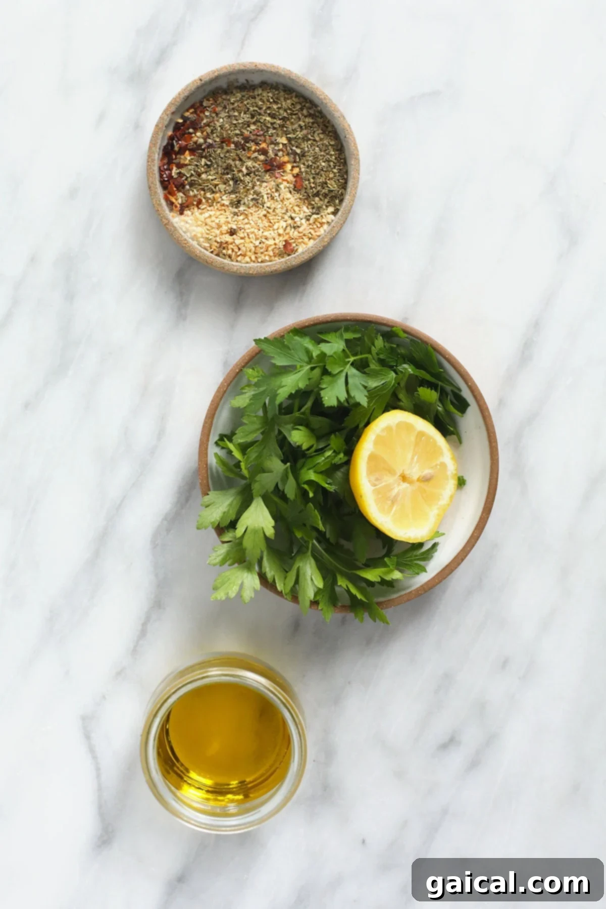 Gather your fresh, high-quality ingredients for the ultimate homemade Italian chicken marinade. An organized display of fresh ingredients for Italian chicken marinade, including lemons, olive oil, a variety of herbs, and spices, on a rustic kitchen countertop.