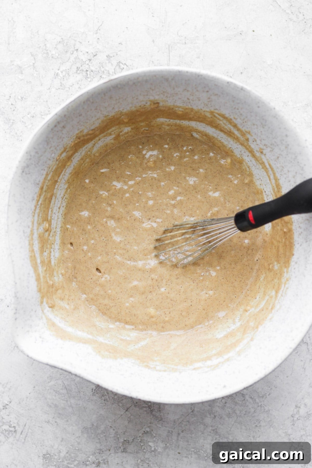 Waffled Cinnamon Rolls 4 A large mixing bowl filled with perfectly combined batter for healthy cinnamon roll waffles, ready for the waffle iron.