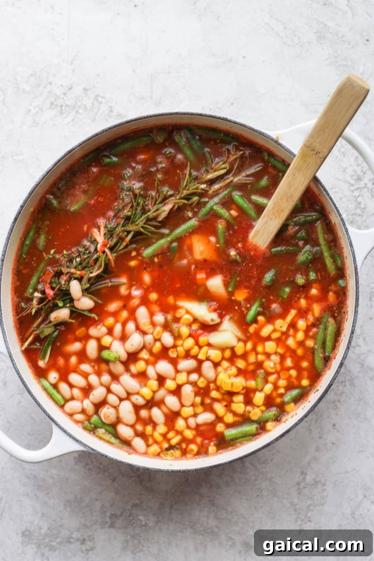Nourishing Garden Harvest Soup 6 A large Dutch oven filled with simmering hearty vegetable soup, vibrant with colorful vegetables and aromatic steam, ready to be served.