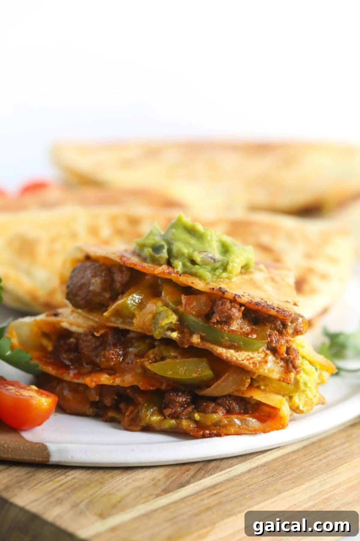 Golden-Grilled Chicken Queso 2 Golden-brown chicken quesadilla topped generously with fresh guacamole and cilantro, ready to be served.