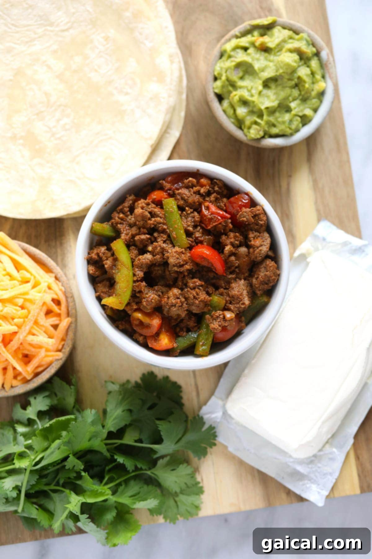 Golden-Grilled Chicken Queso 3 A vibrant array of chicken quesadilla ingredients, including diced onions, bell peppers, tomatoes, ground chicken, and shredded cheese, artfully arranged on a cutting board, ready for assembly.