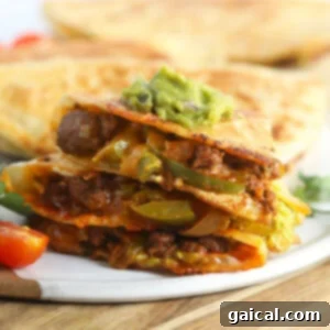 Beautifully sliced chicken quesadillas with visible layers of filling, ready to eat.