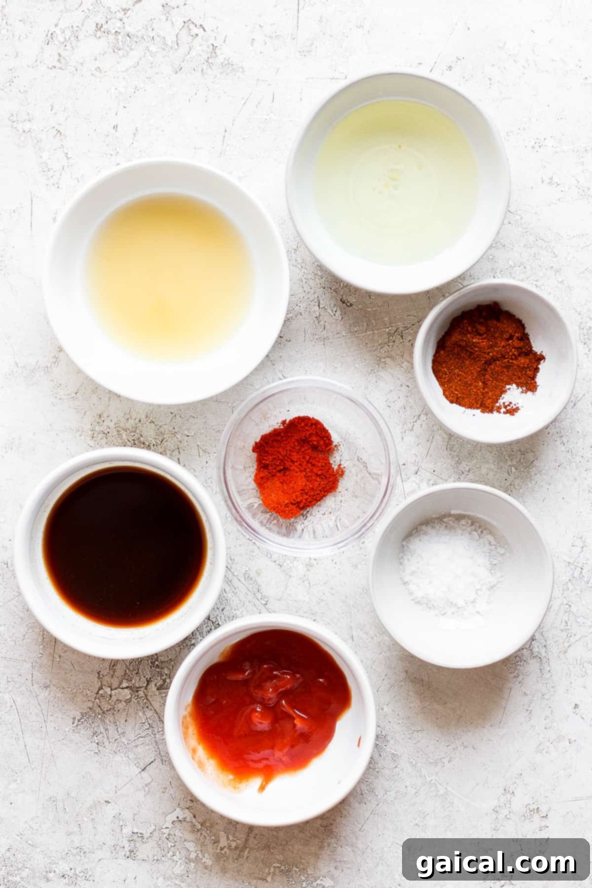 Various ingredients for a dipping sauce including spices and liquids, neatly arranged.