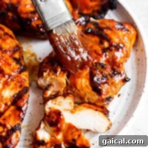 BBQ chicken breast marinating in BBQ sauce.