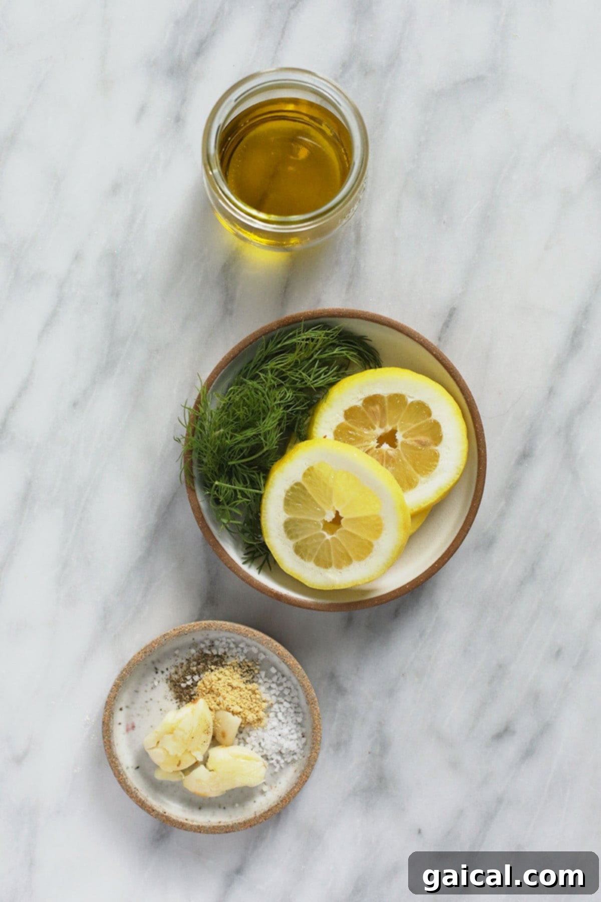 All the fresh ingredients for lemon chicken marinade laid out, including fresh lemons, dill, garlic, olive oil, and honey, ready to be mixed.