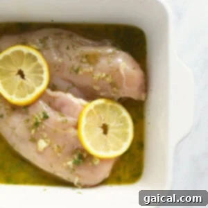 Close-up of a bowl of lemon chicken marinade, highlighting its fresh ingredients and vibrant color.
