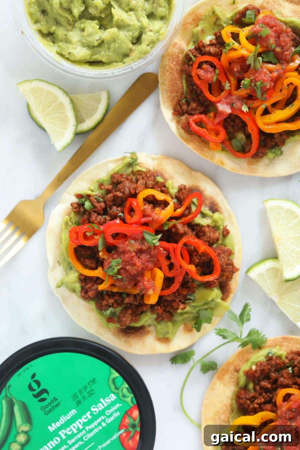 Fresh Vegetarian Tostada with Lime and Peppers Close-up of a beautifully assembled tostada with fresh lime wedges and vibrant mini sweet peppers, ready to be enjoyed.