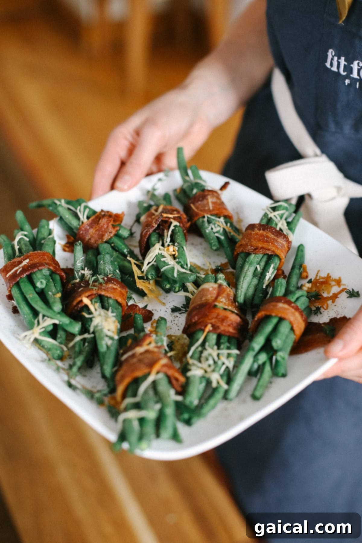 Ready-to-Eat Bacon Wrapped Green Beans A perfectly cooked serving of bacon wrapped green beans, elegantly presented on a plate with vibrant garnishes, ready to be enjoyed as part of a meal.