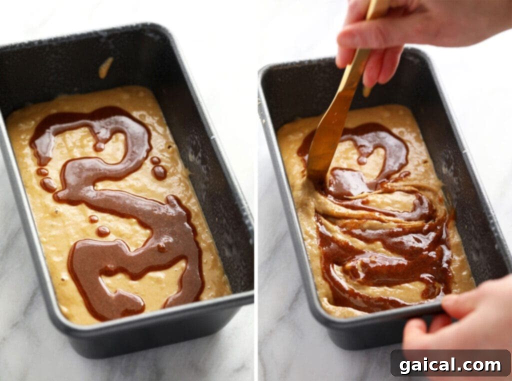 Heavenly Cinnamon Swirl Banana Bread 5 A hand gently creating a cinnamon swirl in the first layer of banana bread batter within a loaf pan.