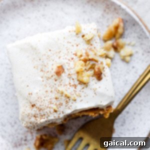 A close-up shot of fluffy, healthy Greek yogurt cream cheese frosting in a bowl, showing its light and creamy texture, ready to be spread.