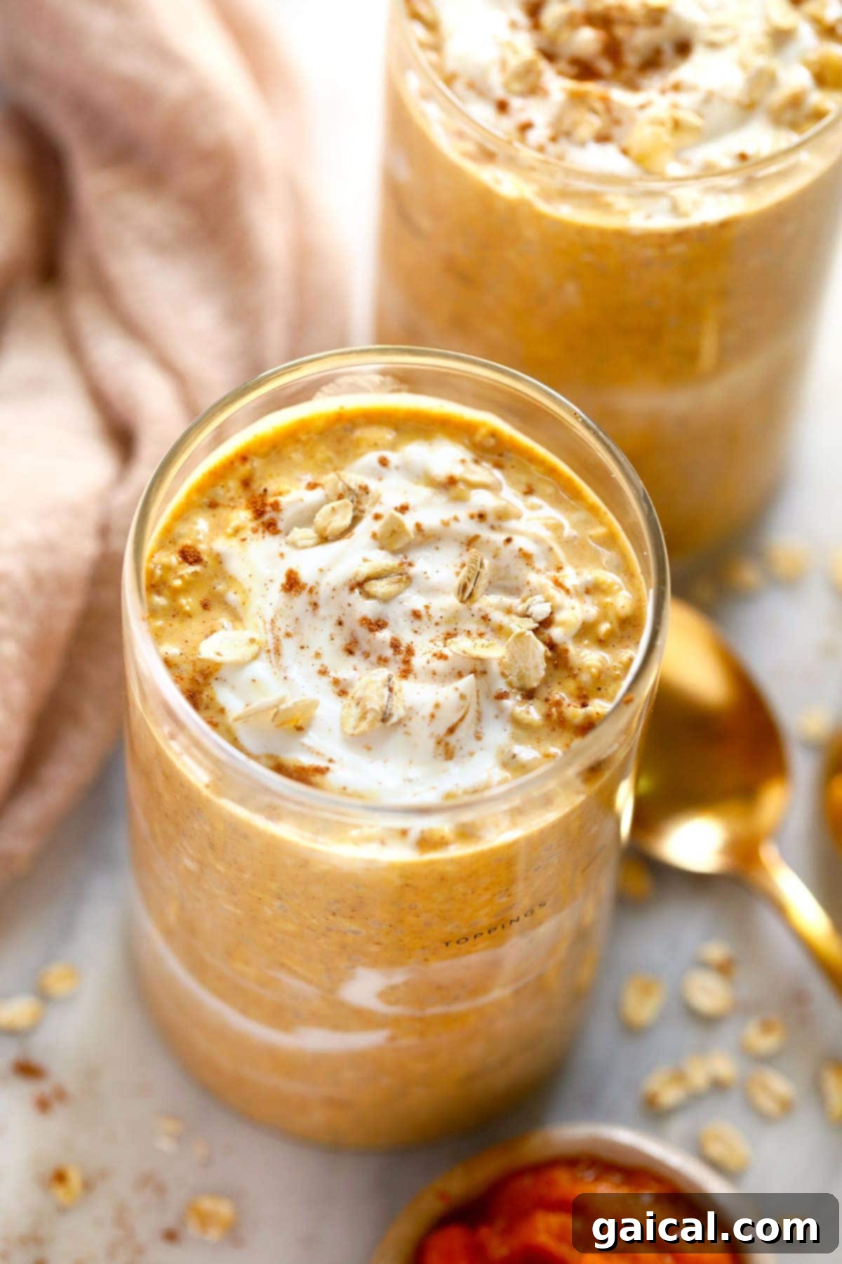 Creamy Pumpkin Cheesecake Overnight Oats in a glass jar, ready to eat, with a cozy autumn background.