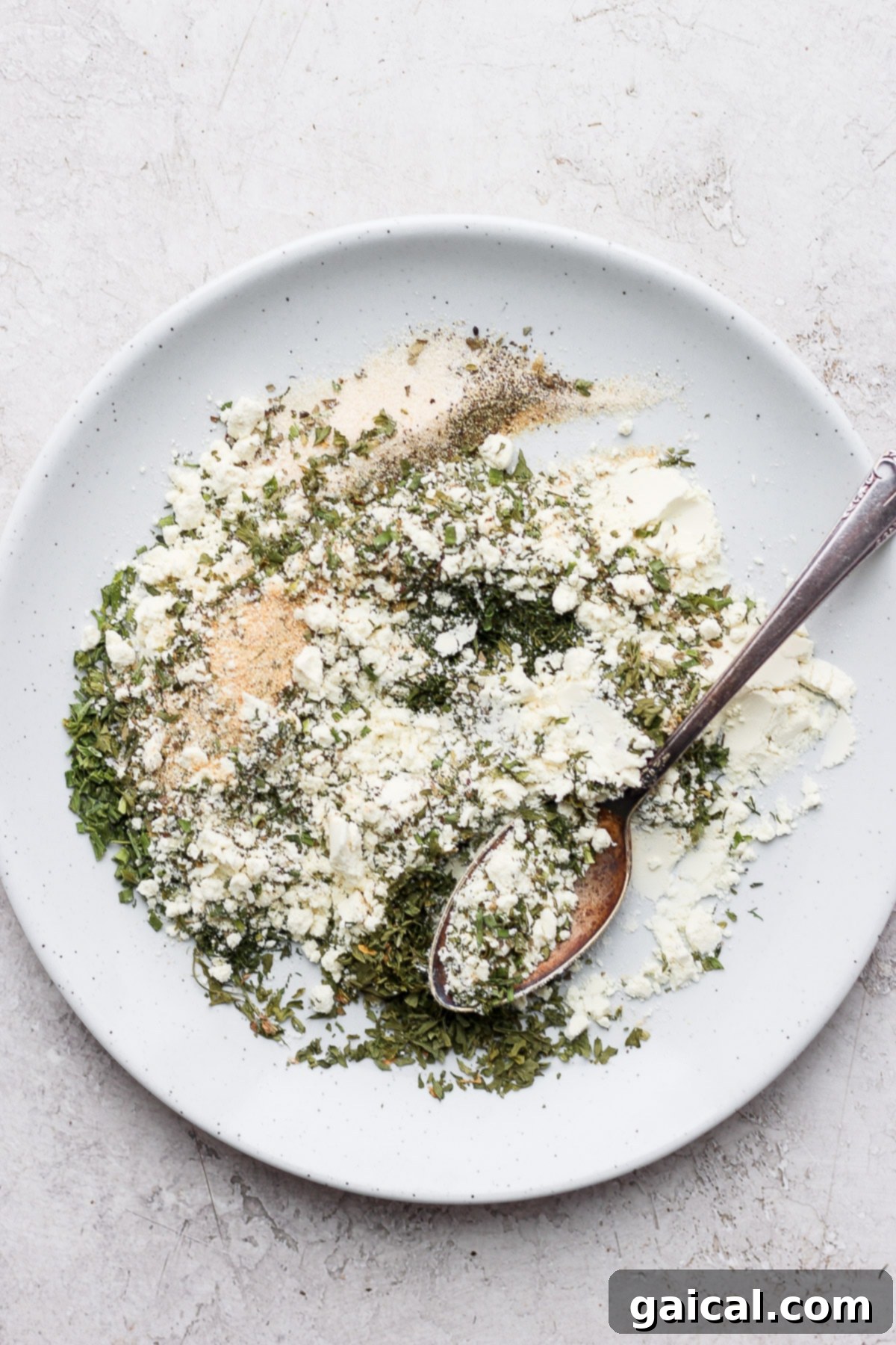 The best homemade ranch seasoning recipe on the internet. You'll want to have a jar of this ranching seasoning over any store-bought packet...trust me! Ranch seasonings mixed on a plate, showing the finely blended texture.
