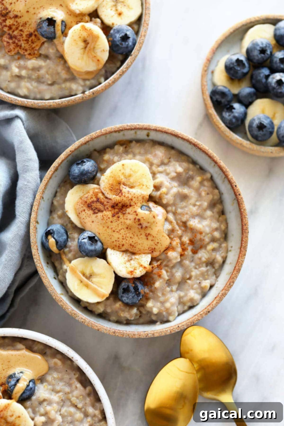 Combine steel cut oats, almond milk, water, mashed banana, and spices in your slow cooker. Set it and forget it and have the most perfect bowl of steel cut oats ready for breakfast! A bowl of creamy steel cut oats topped with fresh banana slices, blueberries, and a dollop of peanut butter, perfect for a hearty and nutritious breakfast.