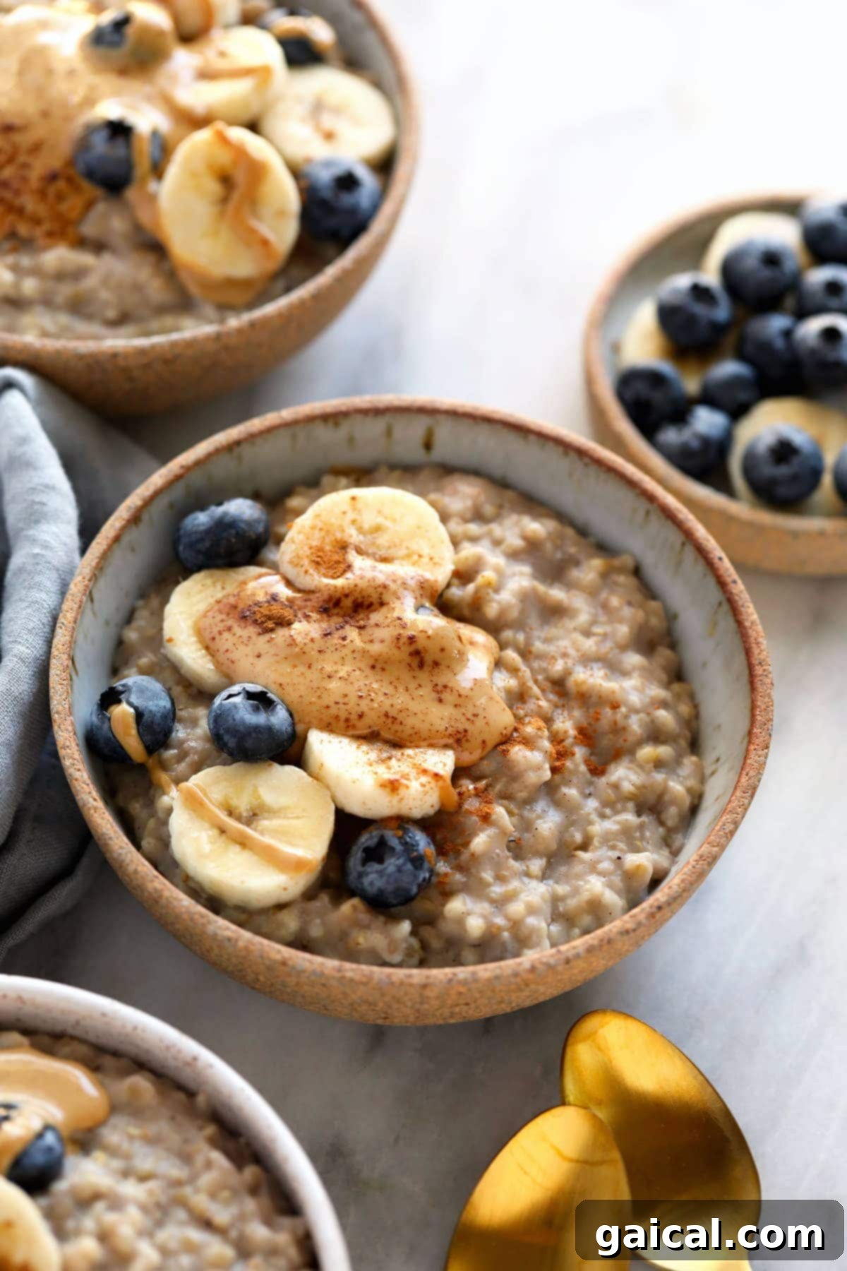 Combine steel cut oats, almond milk, water, mashed banana, and spices in your slow cooker. Set it and forget it and have the most perfect bowl of steel cut oats ready for breakfast! A beautifully presented bowl of steel cut oats topped with sliced bananas, berries, and a sprinkle of cinnamon, ready to be enjoyed.