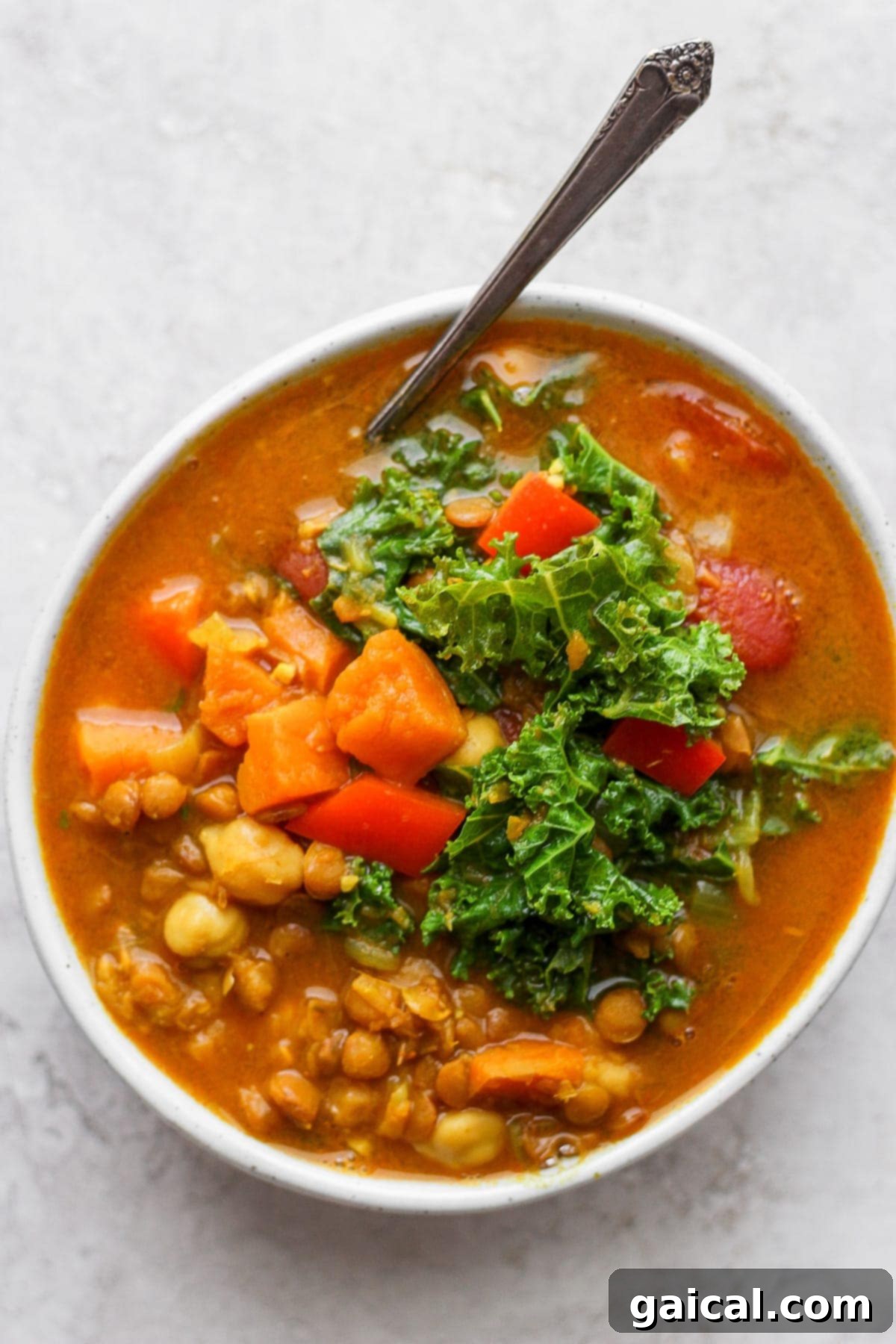 A close-up of a bowl of Instant Pot lentil soup, ready to be eaten.