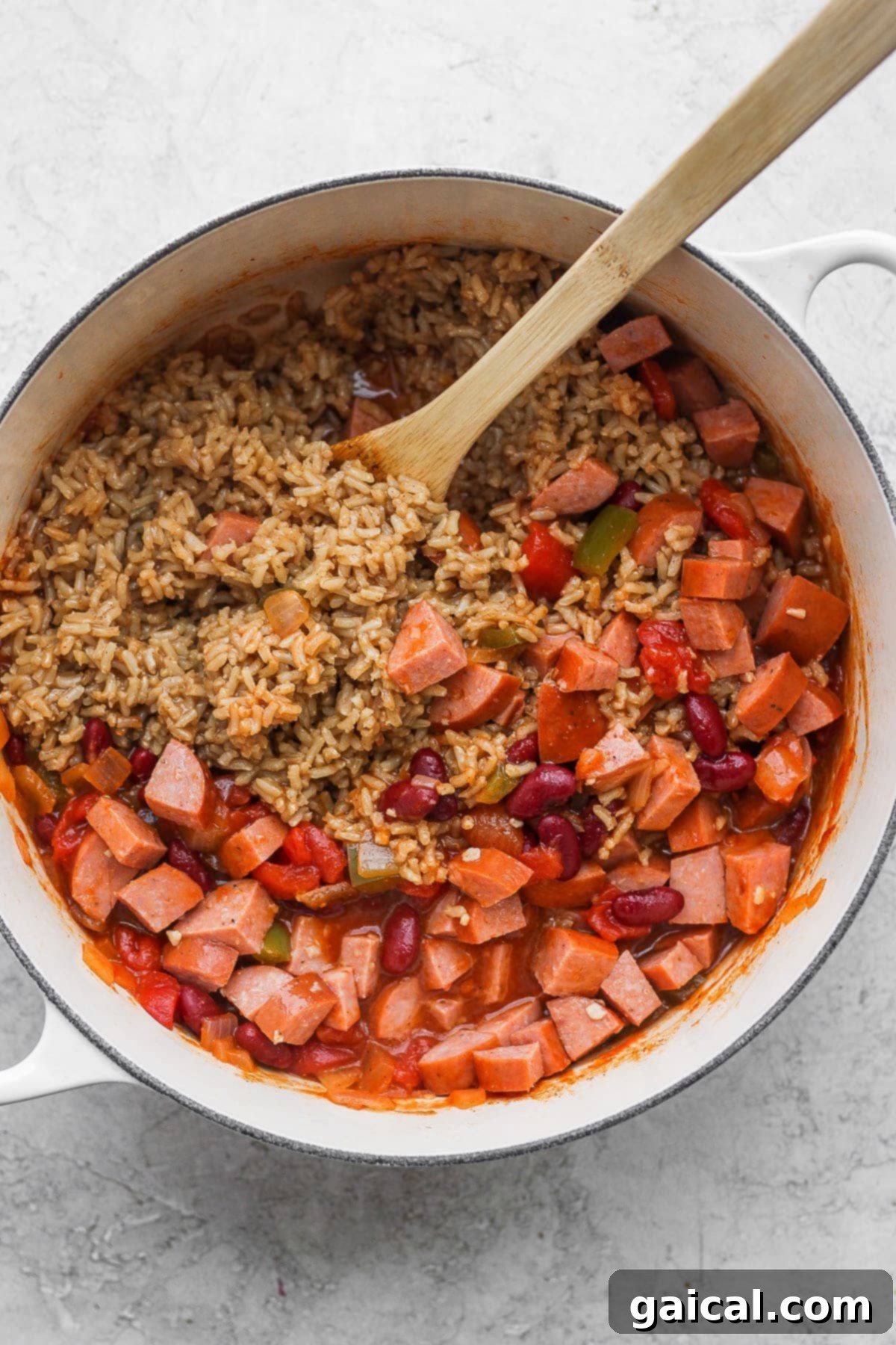 Cooked red beans and rice ingredients in a stock pot, ready to be mixed together for the final simmer