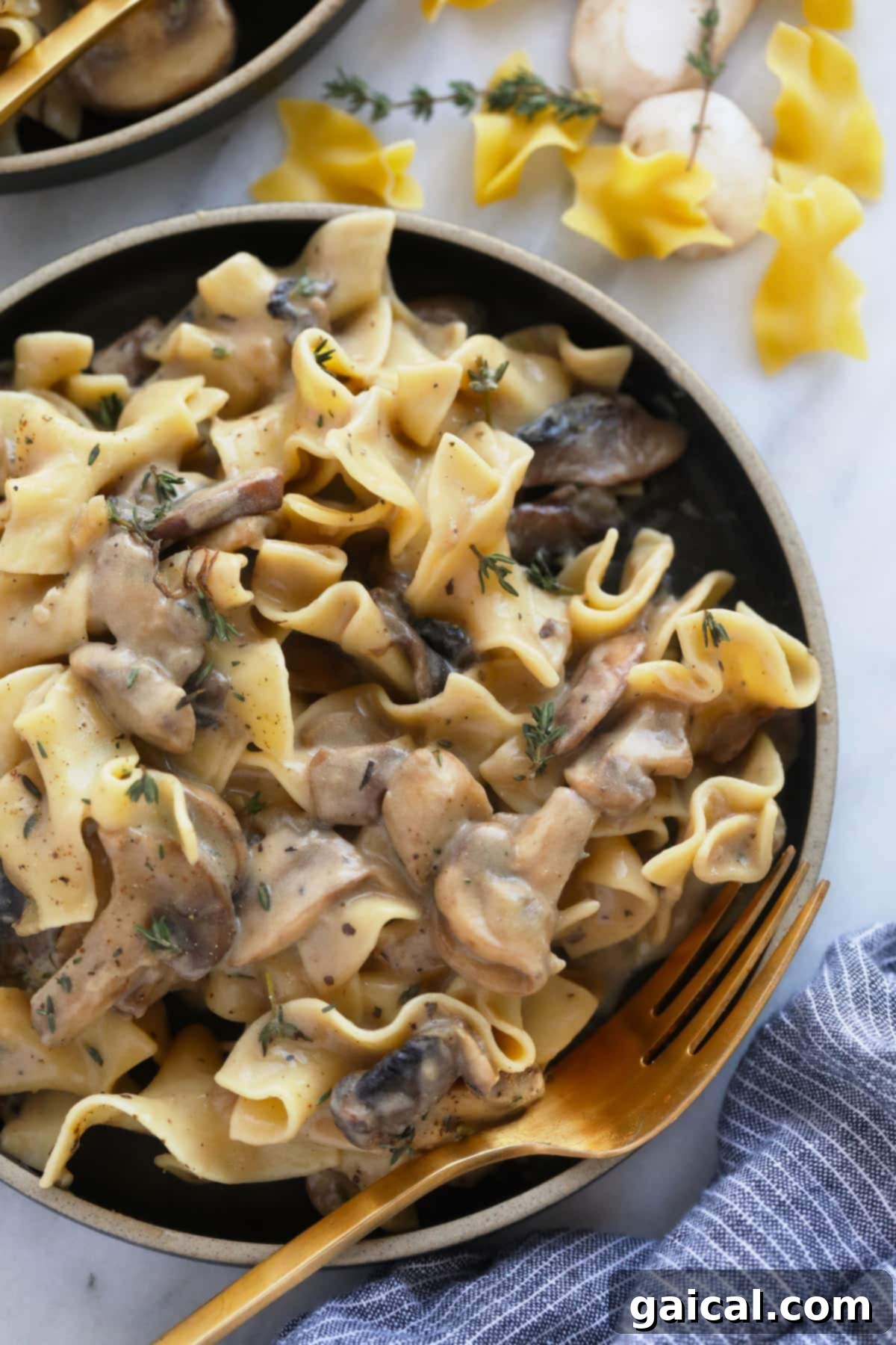 Creamy Mushroom Stroganoff 6 A generous serving of hot, creamy mushroom stroganoff with perfectly cooked egg noodles in a rustic bowl, garnished with fresh dill or parsley, inviting a comforting meal.