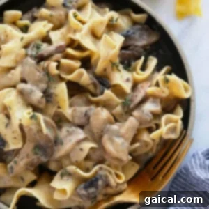 Creamy Mushroom Stroganoff 7 A rich and creamy mushroom stroganoff served in a rustic bowl with a fork, garnished with fresh parsley, ready to be enjoyed.