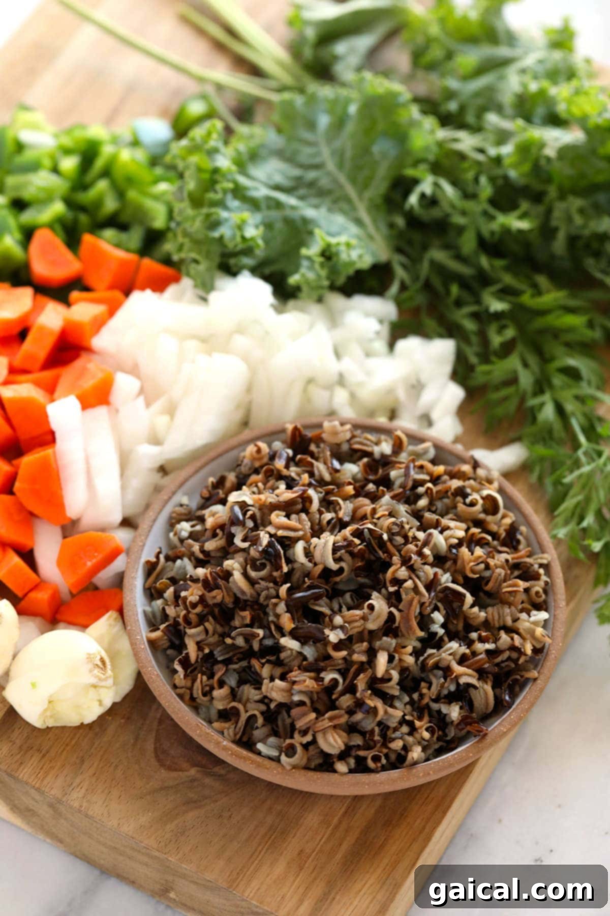 Hearty Chicken Wild Rice Soup 3 Assortment of fresh ingredients for chicken wild rice soup laid out on a counter.