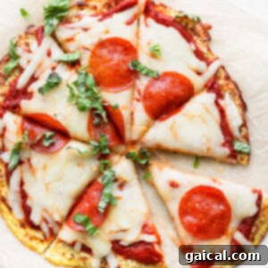Cauliflower pizza on a baking sheet, featuring a golden, crispy crust and melted toppings.