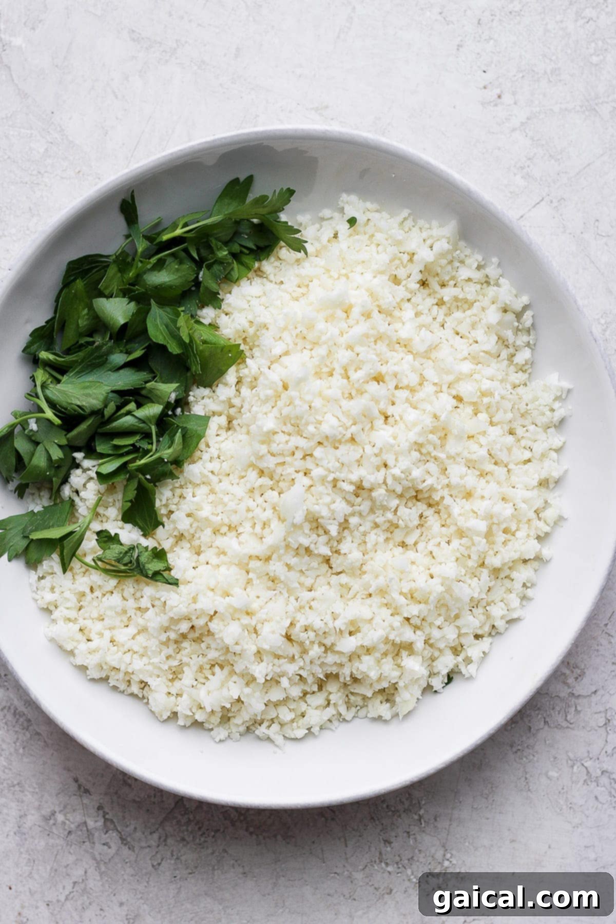 Cauliflower Grains 5 A bowl of freshly made cauliflower rice, ready to be incorporated into a meal.