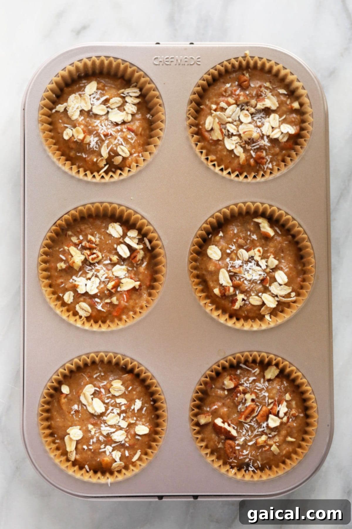 Sunrise Muffins 9 Muffin cups filled three-quarters full with Morning Glory Muffin batter, ready for baking.