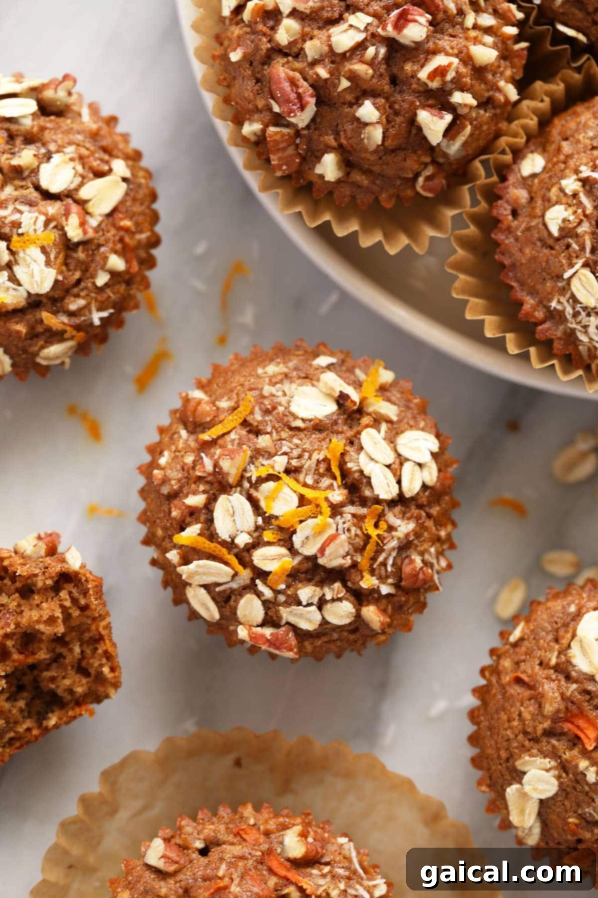 Sunrise Muffins 10 A beautifully golden Morning Glory Muffin garnished with vibrant fresh orange zest on top.
