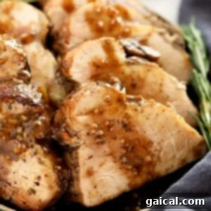 Sliced pork tenderloin with mushroom gravy poured over it.