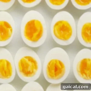 A group of hard boiled eggs on a white surface.