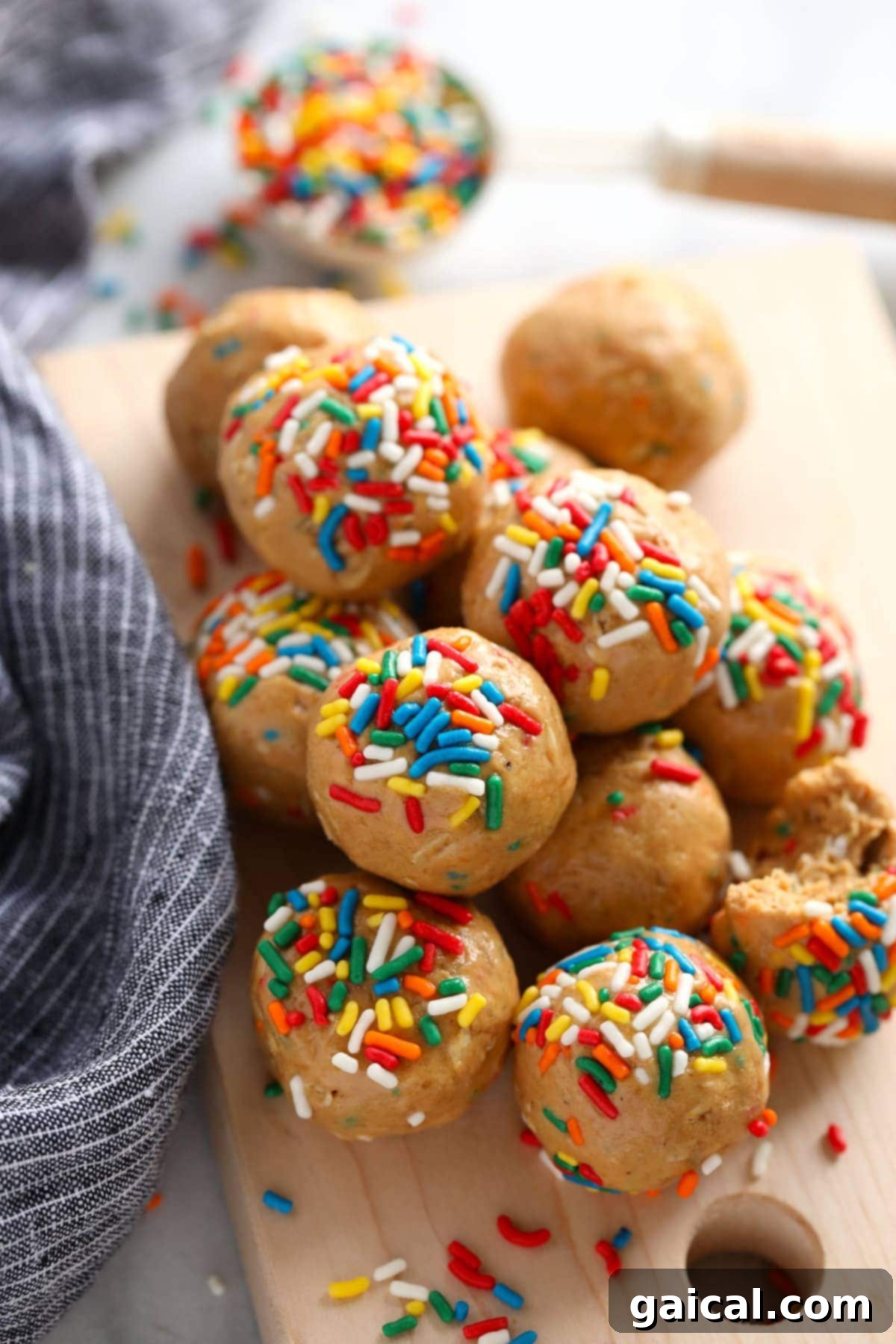 Super flavorful Cake Batter Protein Balls: energy packed from 6 simple ingredients, no food processor required! Vibrant cake batter protein balls adorned with rainbow sprinkles, artfully arranged to highlight their delicious appeal.