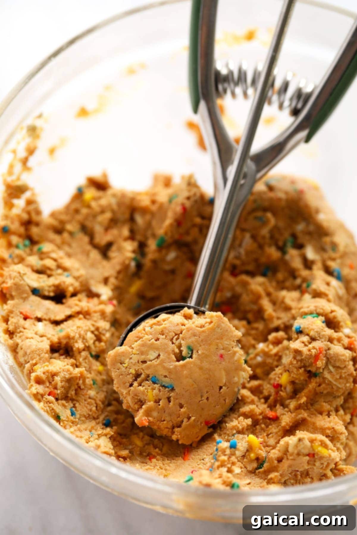 Scooping and Rolling Cake Batter Protein Balls Delicious cake batter protein ball dough being scooped and rolled into individual portions.