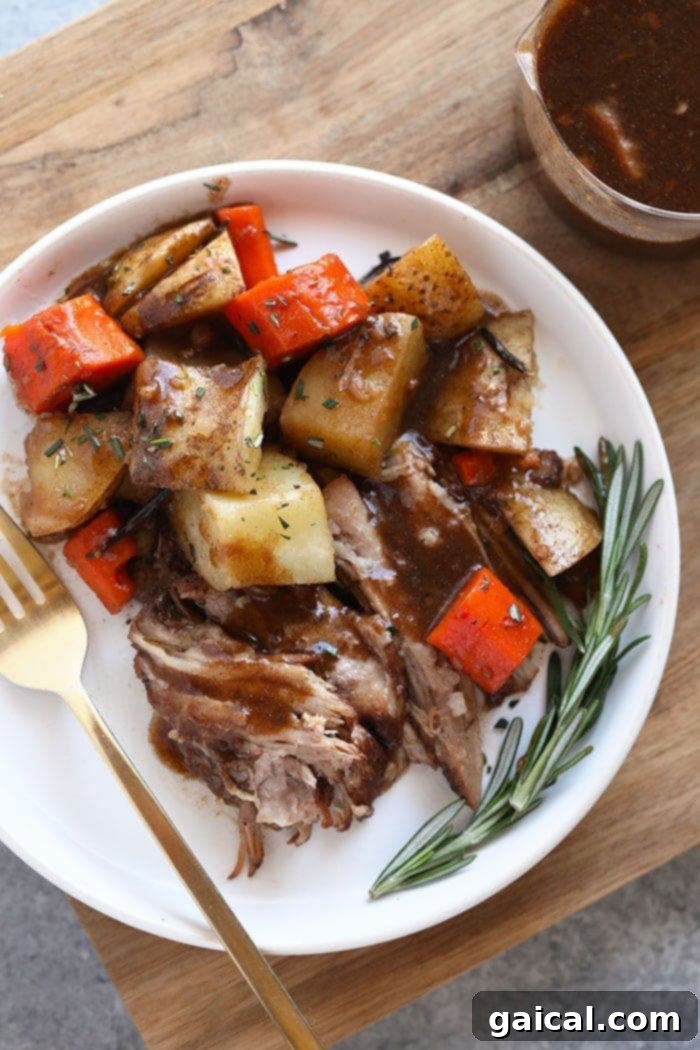 Tender Instant Pot Pork Roast with Root Vegetables A plate of Instant Pot pork roast with tender vegetables.