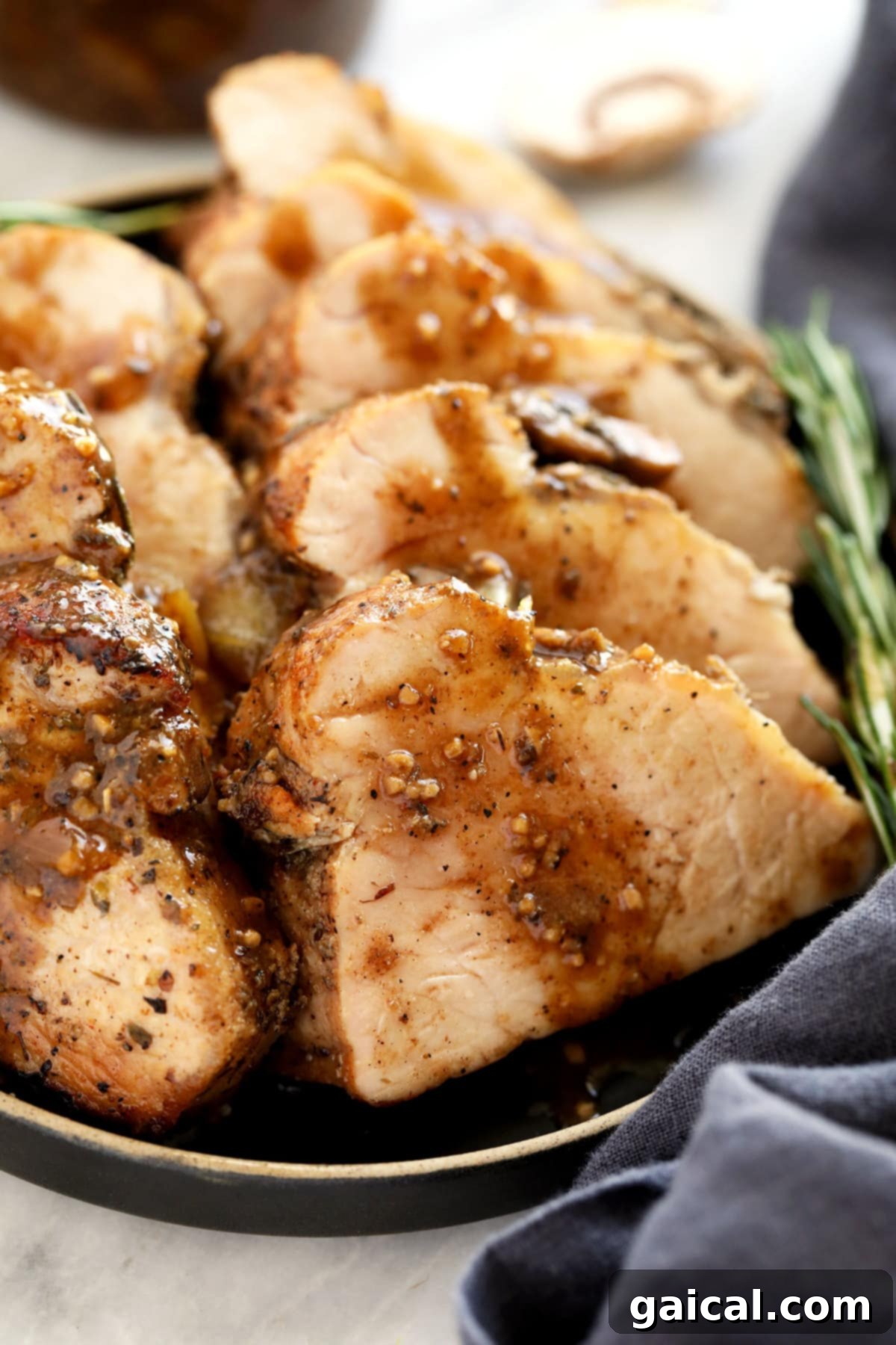 Luscious Honey Sticky Pork and 20 More Pork Recipes 3 Expertly sliced pork tenderloin on a plate, revealing a moist and tender interior.