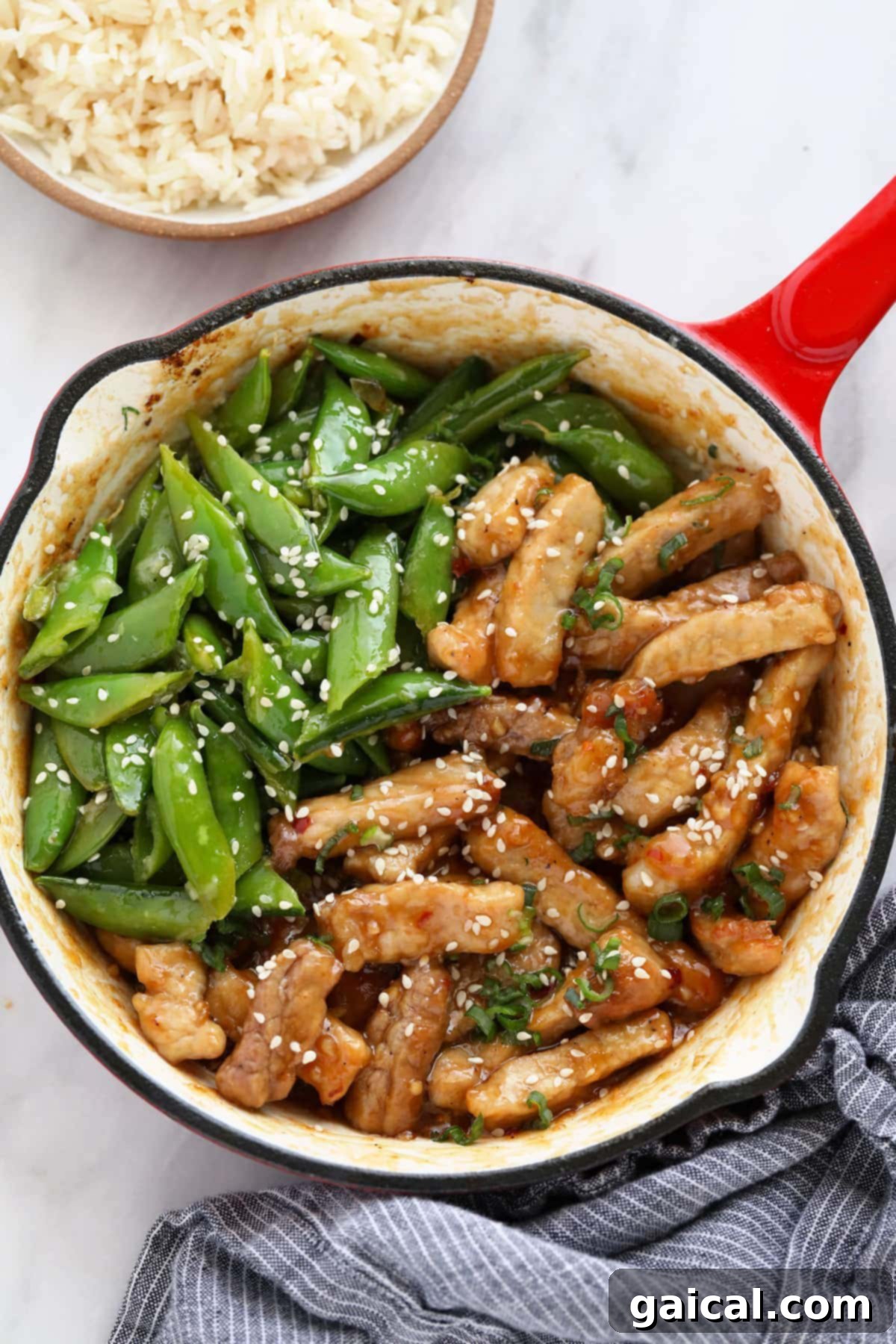 Delicious Sticky Honey Pork Stir-Fry Sticky honey pork stir-fry in a pan, glistening with sauce and ready to serve.