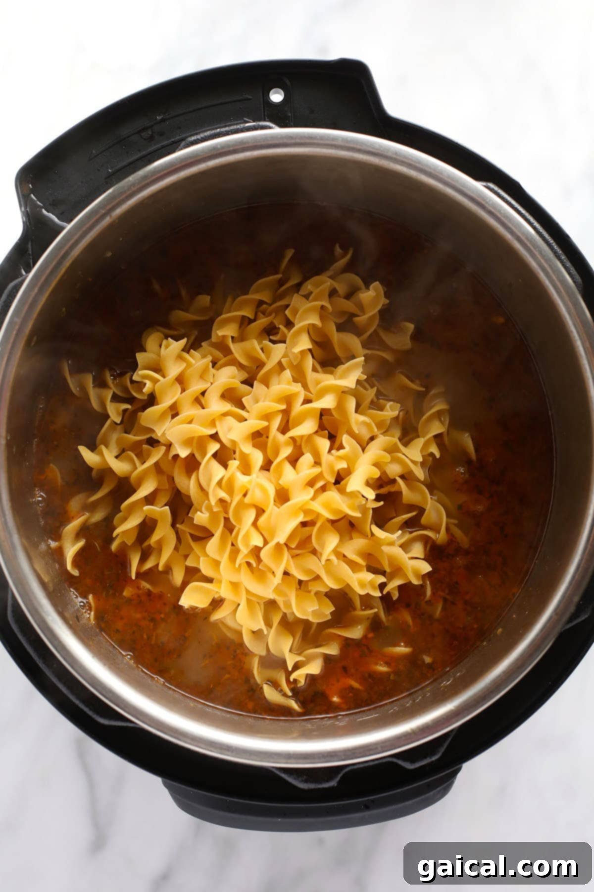 Effortless Instant Pot Chicken Noodle Soup 5 A large pot of Instant Pot Chicken Noodle Soup, steaming hot and ready to be served, with a focus on the rich broth and fresh ingredients.